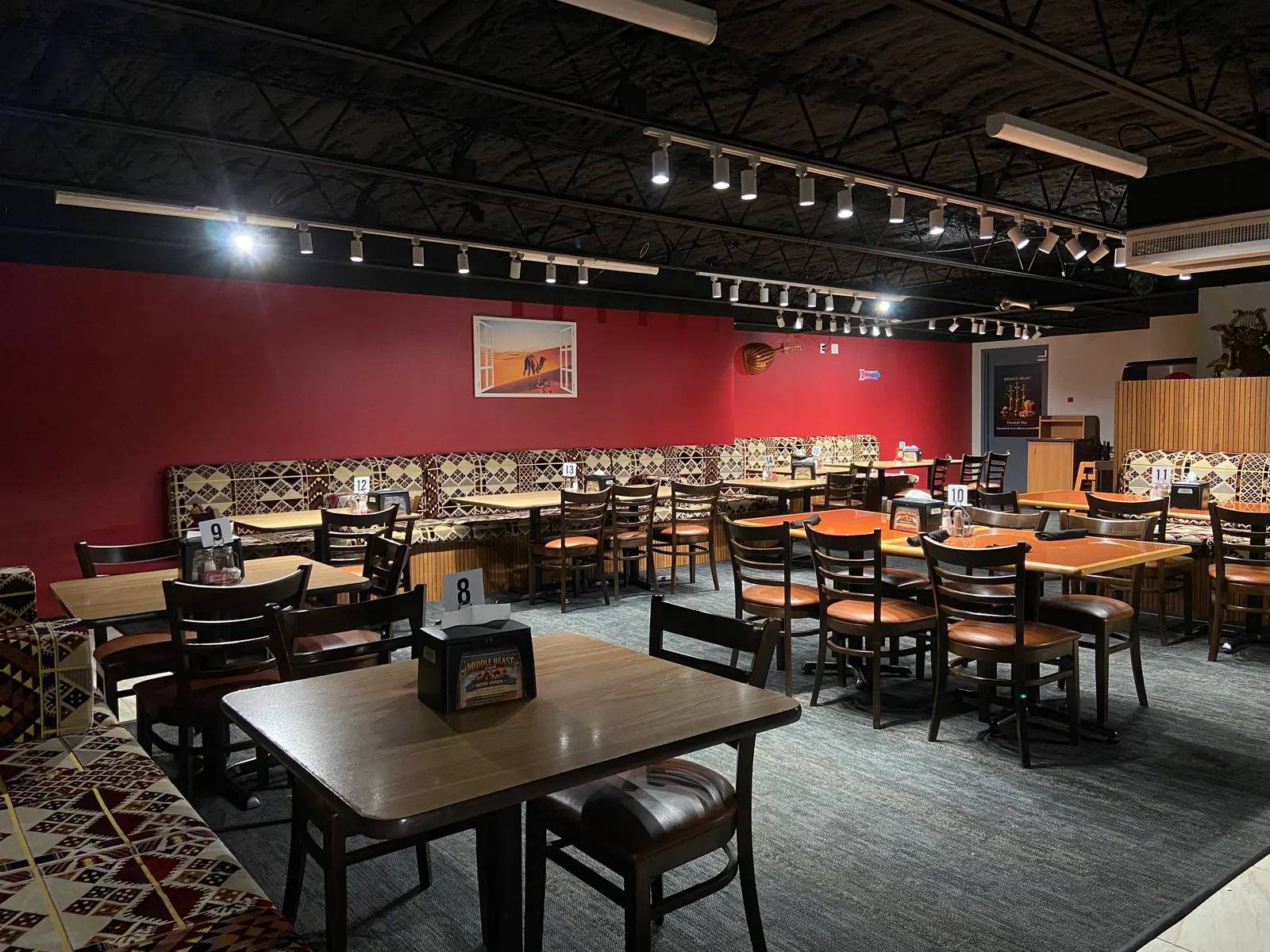 Middle Beast dining room with red walls and patterned banquette seating